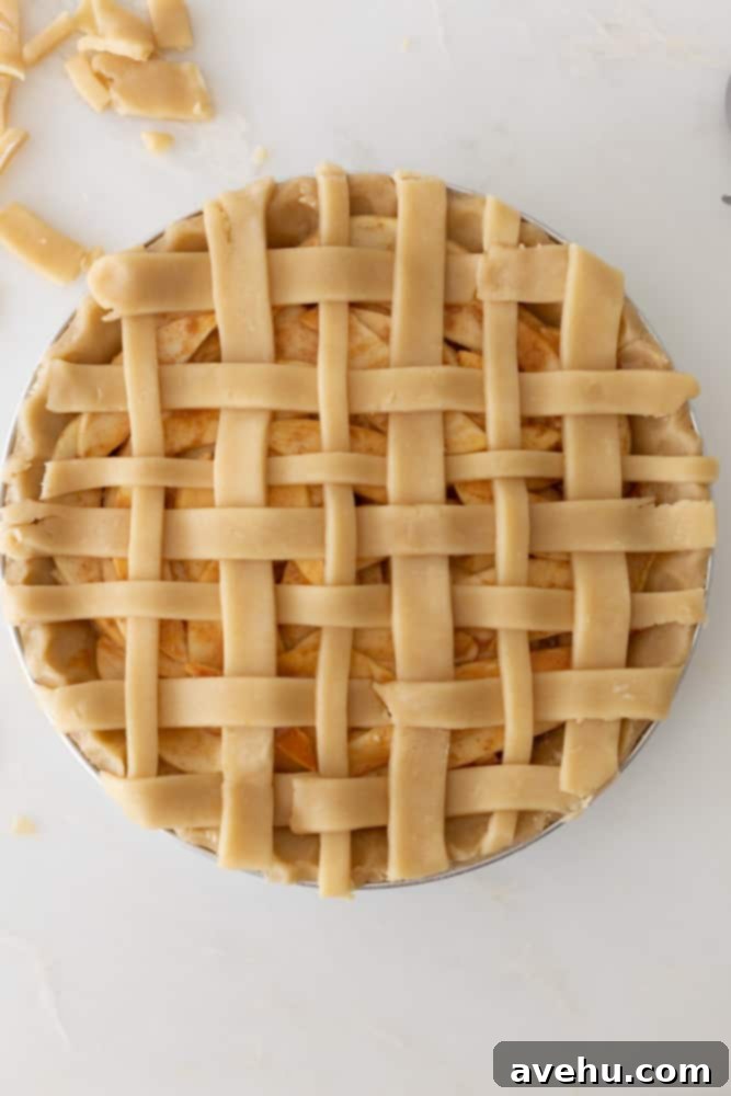 Sweet & Simple Caramel Apple Lattice Pie 16 A completed lattice crust artfully woven over an apple pie, showcasing the beautiful pattern.