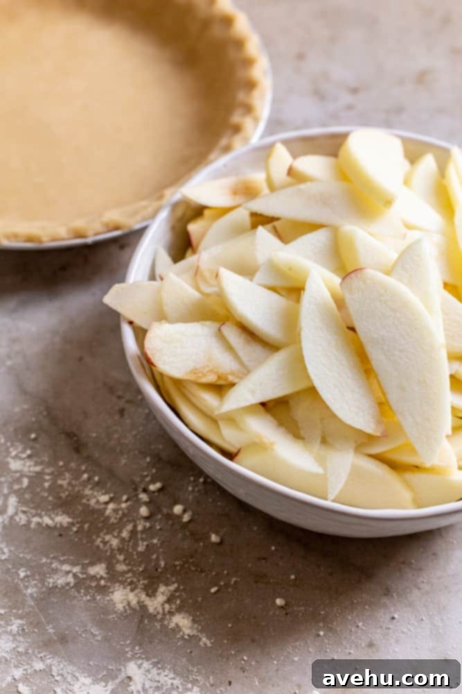Sweet & Simple Caramel Apple Lattice Pie 3 Freshly peeled and sliced apples ready for the pie filling, arranged in a white bowl.