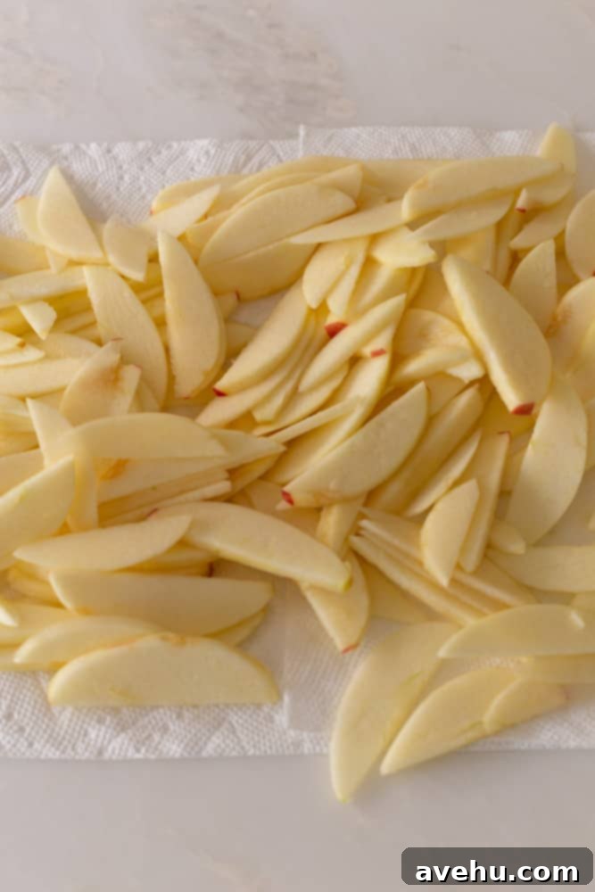 Sweet & Simple Caramel Apple Lattice Pie 4 Sliced apples spread out on paper towels to thoroughly dry, a crucial step for a perfect pie filling.