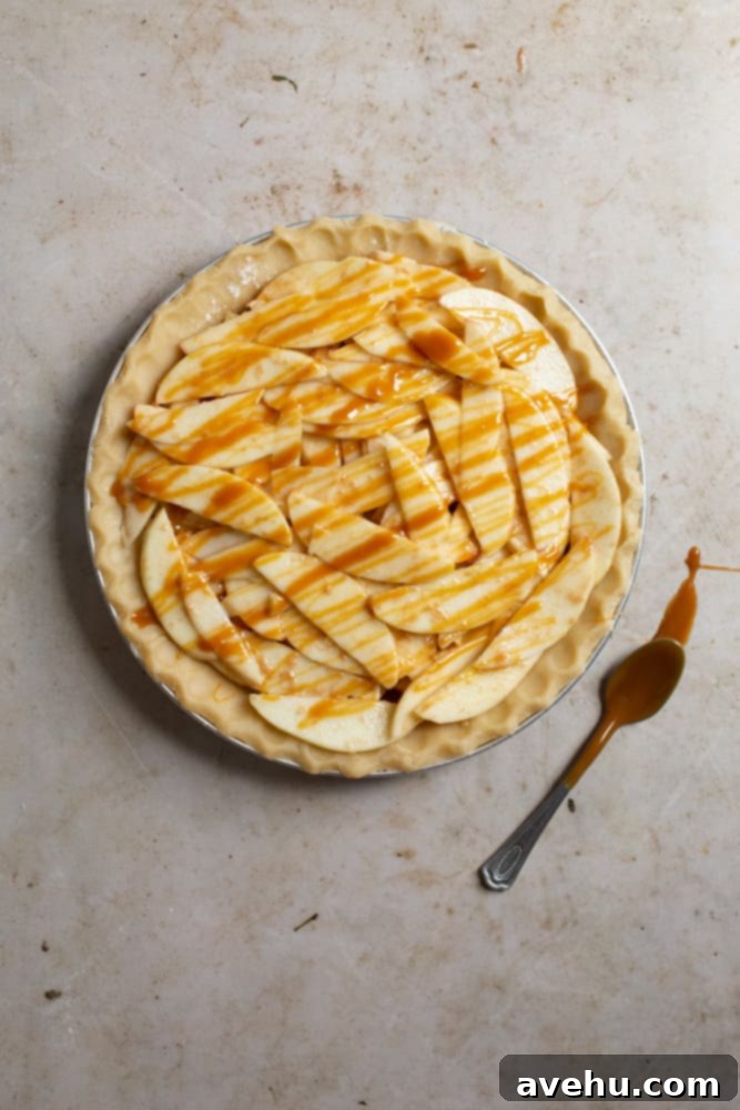 Sweet & Simple Caramel Apple Lattice Pie 7 An unbaked pie crust filled to the brim with multiple layers of spiced apple slices and salted caramel.