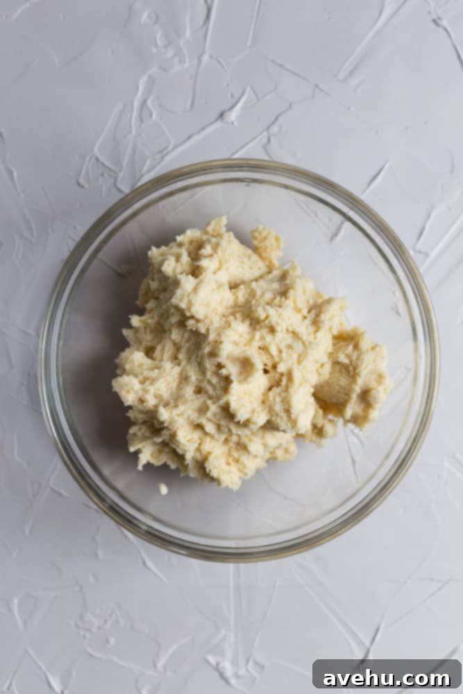 Cloud-Soft Italian Ricotta Cookies 5 Chilled Italian ricotta cookie dough resting firmly in a clear glass bowl, ready for scooping and baking.
