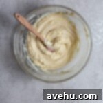 Creamy Raspberry Thumbprint Delights 12 Creamed butter and sugar in a glass bowl on a gray surface