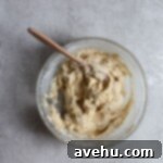 Creamy Raspberry Thumbprint Delights 13 Cookie dough in a glass bowl on a gray surface