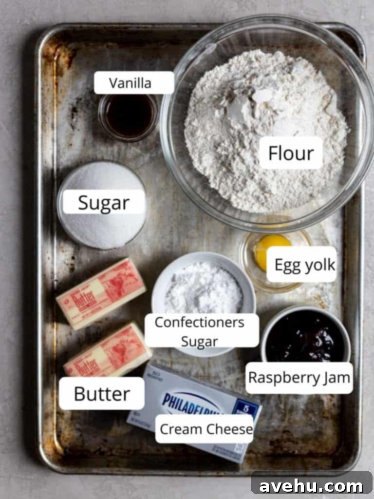 Creamy Raspberry Thumbprint Delights 3 Collection of ingredients for making cream cheese thumbprint cookies laid out on a gray surface.
