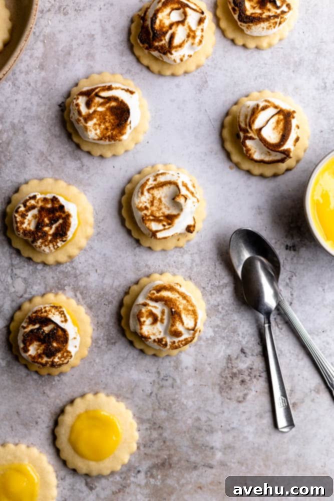 Zesty Lemon Curd Clouds 4 Lemon meringue cookies on a gray background