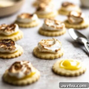 Zesty Lemon Curd Clouds 5 Closeup of a lemon meringue cookie with spoons in the background