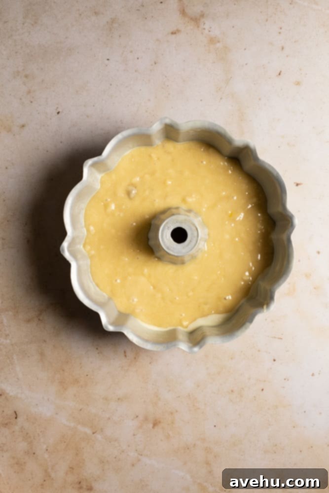 Deliciously Easy Banana Bundt Cake 5 Banana cake batter poured into a well-greased bundt pan, ready for the oven.