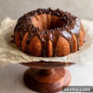 Banana Bundt cake with chocolate glaze on a wooden cake stand