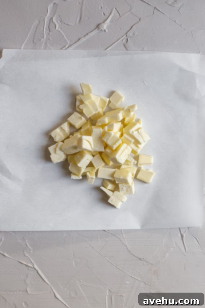 Easy Classic Streusel Crumbs Nut and Oat Free 4 Diced cold butter on a piece of parchment paper, ready to be incorporated into streusel ingredients