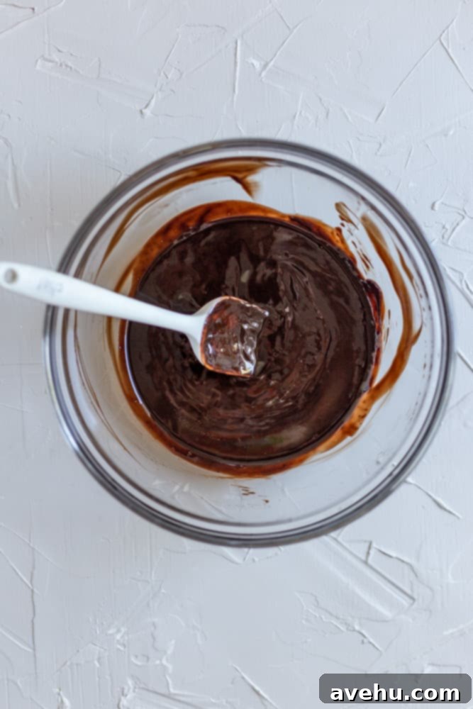 Decadent 30-Minute One-Bowl Fudgy Brownies 2 Melted butter and chocolate chips in a clear glass bowl, showcasing the smooth, glossy texture