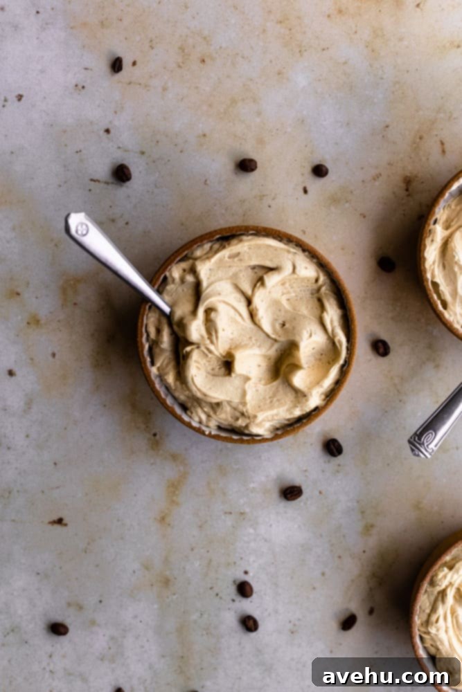 Quick Coffee Buttercream in 5 Minutes 2 Coffee frosting in a small bowl on a marble backdrop