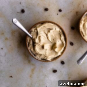 Quick Coffee Buttercream in 5 Minutes 8 Coffee frosting in a small bowl on a marble backdrop