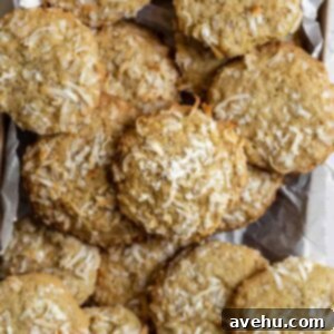 Delicious crispy and chewy coconut cookies arranged on a white serving platter.