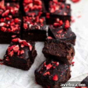 Quick Strawberry Fudge Brownies 11 Brownies with strawberries on top on a piece of parchment paper