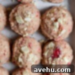 Decadent Strawberry Chewies 7 Strawberry cookie dough balls on a cookie sheet
