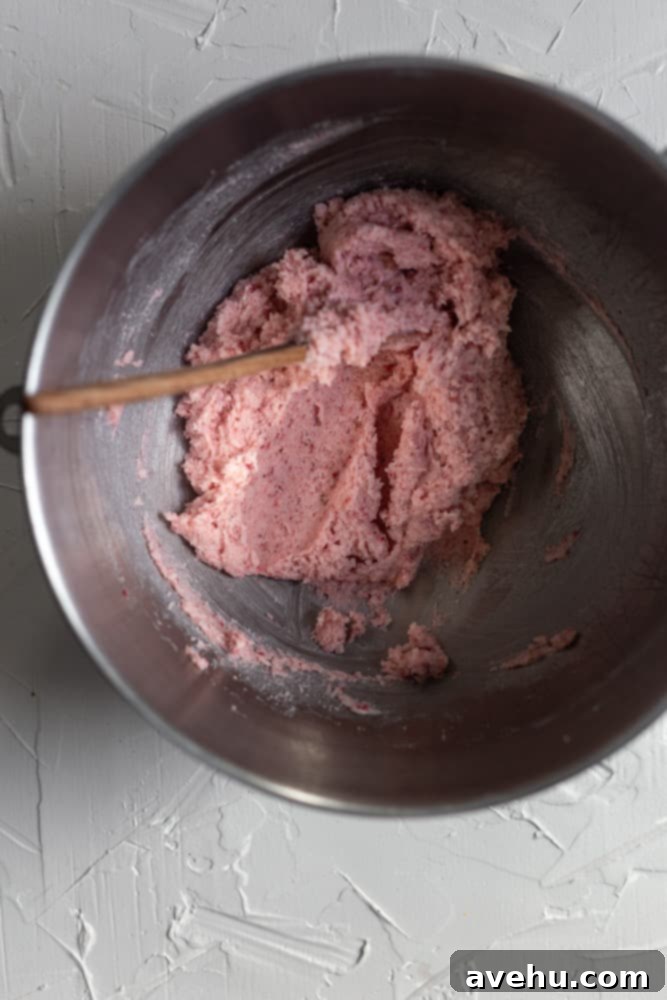 Decadent Strawberry Chewies 11 A mixing bowl containing a creamy blend of softened butter, sugar, and freeze-dried strawberries, a key step in creating the cookie dough.