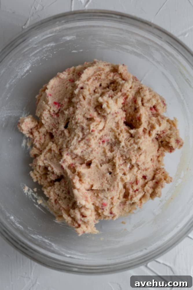 Decadent Strawberry Chewies 12 A glass bowl filled with rich, pink strawberry cookie dough, ready for portioning and baking.