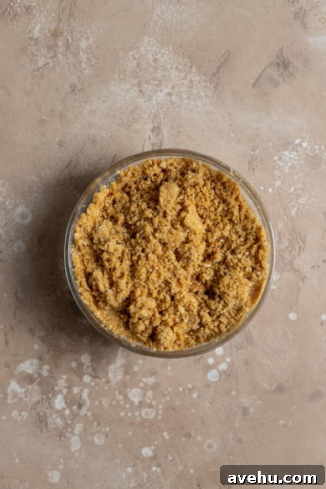 Irresistible Mini Cheesecake Treats 4 Graham cracker crust in a glass bowl on a beige surface