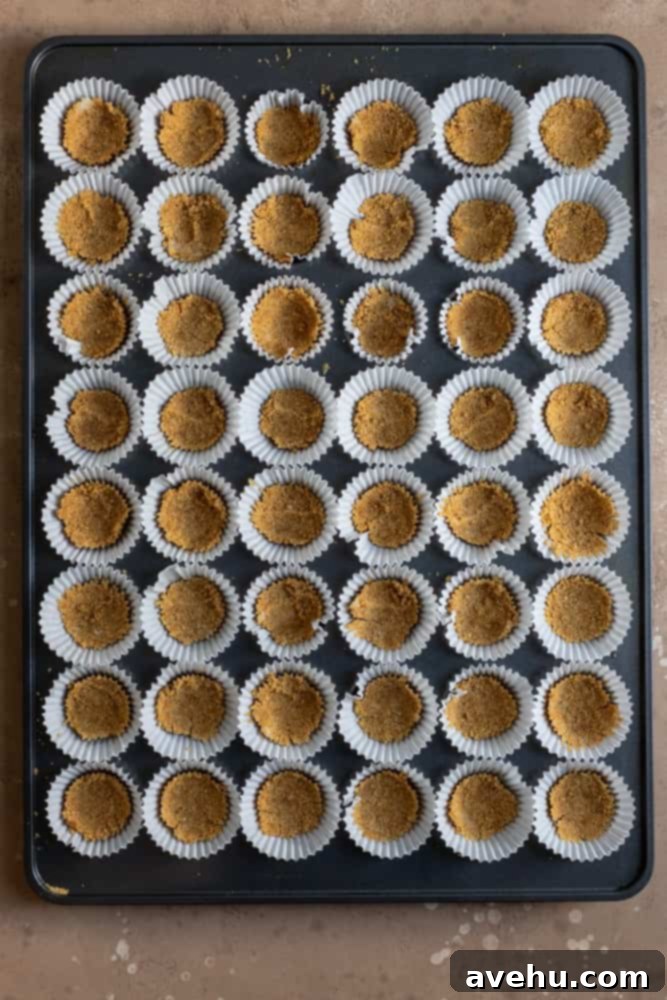 Irresistible Mini Cheesecake Treats 5 A mini muffin tin lined and filled with graham cracker crust