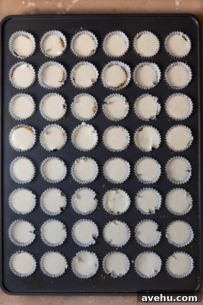 Irresistible Mini Cheesecake Treats 7 A mini muffin tin filled with cheesecake batter