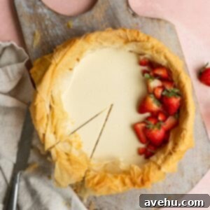 A slice cut into a strawberry cheesecake that has a phyllo dough crust