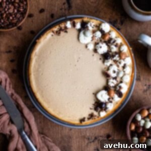 Coffee cheesecake decorated with whipped cream and chocolate on a wooden surface