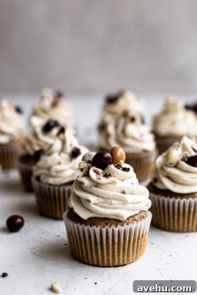 Ultimate Coffee Dessert Delights 2 A dozen espresso cupcakes topped with chocolate covered espresso beans on a gray surface, showcasing a perfect blend of rich coffee and sweet chocolate.