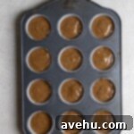 Irresistibly Fluffy Espresso Cupcakes 5 Cupcake batter in a 12 cup muffin tin on a grey surface