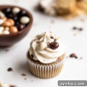 Irresistibly Fluffy Espresso Cupcakes 2 Espresso cupcakes on a white surface next to chocolate covered espresso beans in a bowl