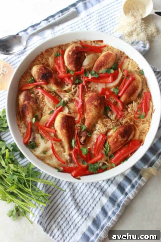 Simple and Savory Arroz Con Pollo 2 Flavorful one-pan Arroz con Pollo with chicken, rice, onions, and peppers, ready for serving