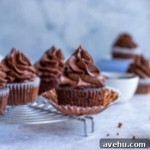 Chocolate filled cupcakes on a cooling rack with its wrapper undone