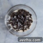 Chocolate and cream in a glass bowl on a blue surface