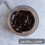 Chocolate ganache melted in a glass bowl