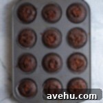 chocolate cupcakes filled with ganache in a 12 pan cupcake tin