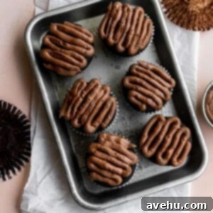 Six beautifully frosted small batch chocolate cupcakes on a small sheet tray, showcasing their delicious appeal.
