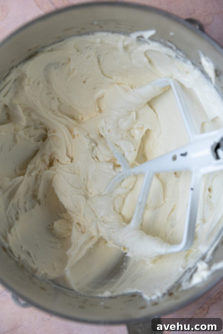 Effortless Pipeable Cream Cheese Frosting 6 Finished, fluffy cream cheese frosting in a mixing bowl, ready for use.