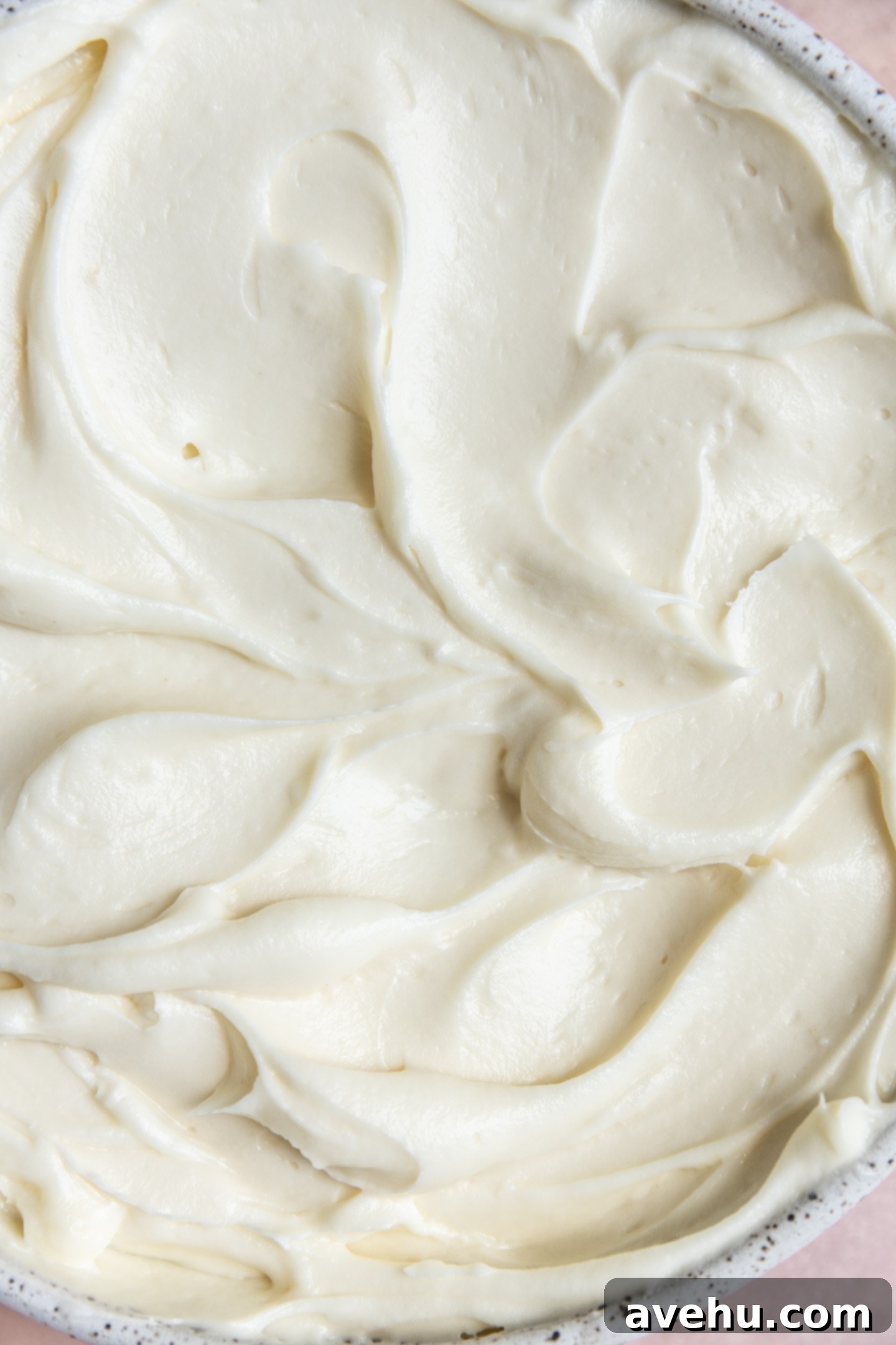 Effortless Pipeable Cream Cheese Frosting 7 Smooth and thick cream cheese frosting in a bowl, showcasing its perfect texture.