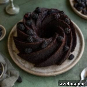 Decadent Chocolate Bundt Cake 2 A chocolate bundt cake with blackberries garnished on top.