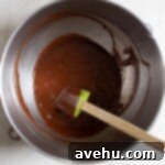 Chocolate batter in a stainless steel bowl