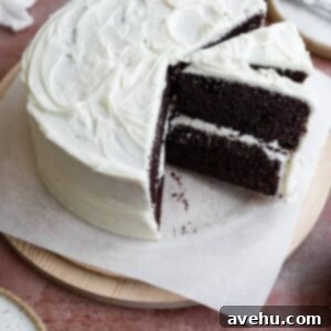 Effortless Chocolate Delight with Cream Cheese Frosting 2 A chocolate cake with a few slices cut out and one on a diagonal next to the full cake.