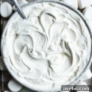 Whip Up Dreamy Marshmallow Frosting in 5 Minutes 2 A close up of a bowl with marshmallow frosting swirled inside, fluffy and ready for use