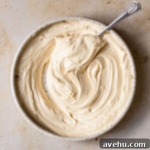 Velvety Brown Sugar Buttercream 2 A bowl of smooth, light brown sugar buttercream frosting with a spoon, ready for use.