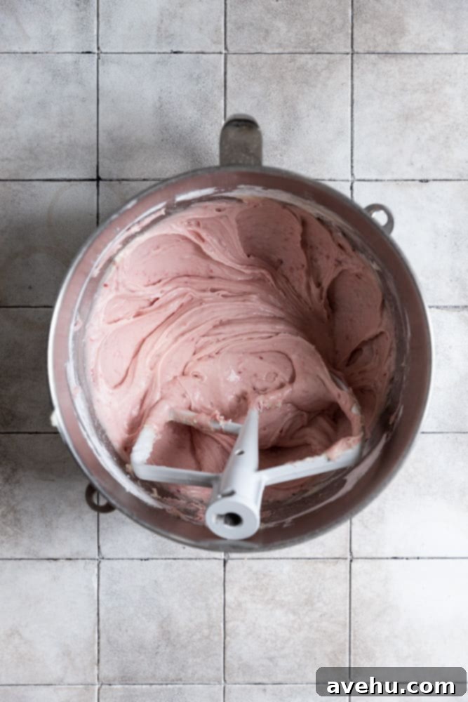 Raspberry Jam Cream Cheese Frosting 2 The fully mixed raspberry cream cheese frosting, smooth and vibrant pink, ready to be spread.