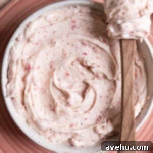 Strawberry cream cheese frosting in a white bowl.