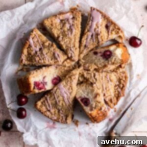 Pillowy Cherry Streusel Coffee Cake 2 A cherry coffee cake cut into slices on parchment paper.