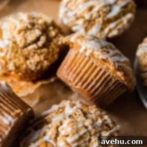 Coffee cake muffins arranged on a peach colored backdrop.