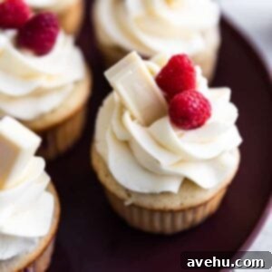 Effortless 10-Minute Fluffy White Chocolate Frosting 2 Raspberry cupcakes with fluffy white chocolate buttercream frosting.