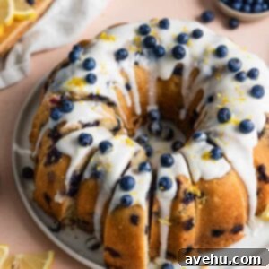 Bright Citrus Berry Bundt Bliss 2 A lemon bundt cake with slices cut out of it.
