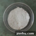 Deliciously Simple Gingerbread Bundt 5 Flour in a bowl on a green surface.