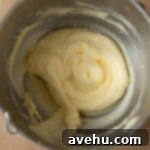 The addition of eggs and oil to creamed butter and sugar.